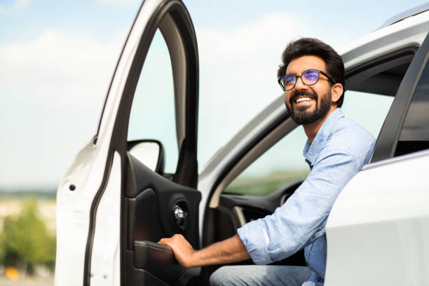 istock Happy eastern man going out the car, low angle photo 1791837745