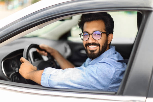 istock Excited eastern guy going to office in morning, driving car 1791837748