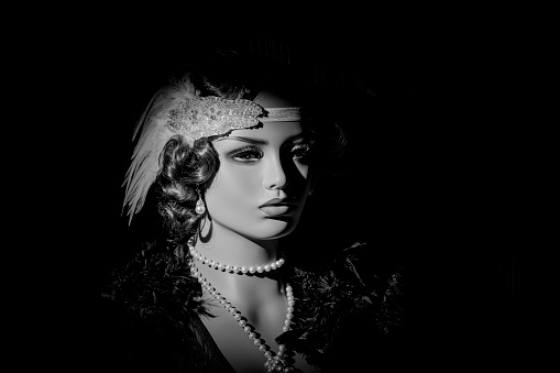 Portrait sexy woman in twenties old style beautiful face professional makeup retro dress ostrich feather boa cold wave hairstyle. Classic sepia black and white vintage photo. Roar 1920s fashion model.