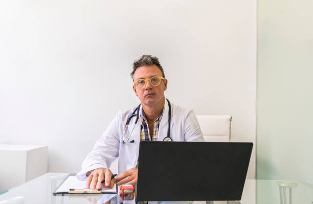 istock Male doctor working in medical office while looking at camera 1791838784