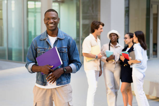 istock Cheerful african american guy posing at university campus 1791849826