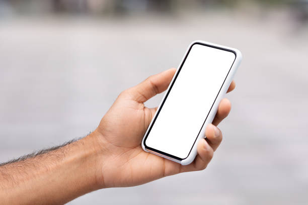 istock Unrecognizable man hand holding phone with white blank screen 1791858351