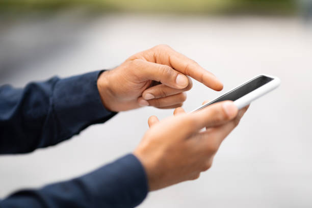 istock Cropped of man hands using phone with empty black screen 1791858362