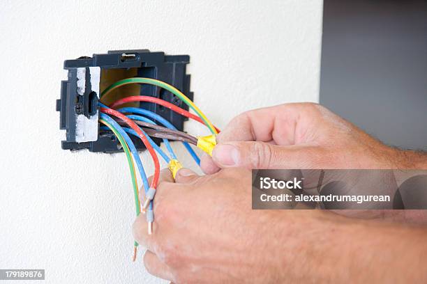 Installing Power Outlet Stock Photo - Download Image Now - Bib Overalls, Blue-collar Worker, Built Structure