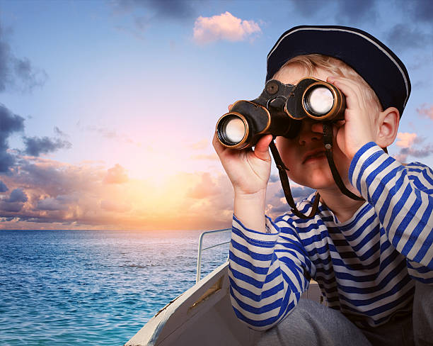 istock Sailor boy with binoculars in the boat 179190042