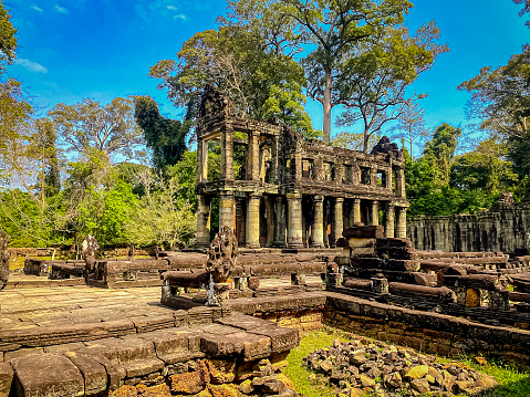 Siem Reap, Cambodia - January 22, 2020: The giant tree roots are going over Ta Prohm Temple, Angkor Wat, Cambodia. Ta Prohm is the temple in Siem Reap, Cambodia, built in the Bayon style largely in the late 12th and early 13th centuries by Khmer King Jayavarman VII.