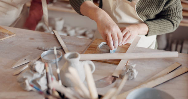 istock Creative artist, hands and pottery manufacturing closeup in studio, workshop craft and small business for production process. Clay, ceramic designer and artisan mold mud sculpture in class at table. 1791907625