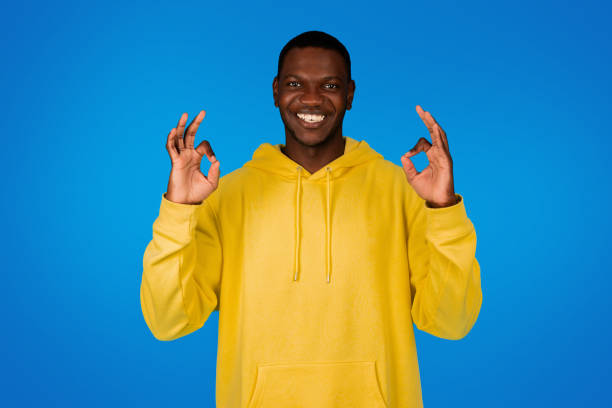 istock Positive young black guy show ok sign with hands, has fun, isolated on blue background 1791909774