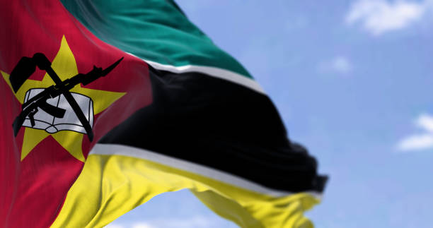 istock Mozambique Flag Waves Under Blue Sky 1791909780