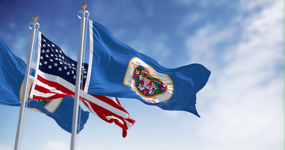 Minnesota state flag waving with the national american flag on a clear day. state in the upper Midwest and northern regions of the United States. 3d illustration render. Rippled fabric