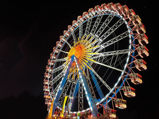 istock Illuminated ferris wheel side on at night 1791918078