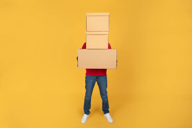 istock Millennial black man courier in red uniform hold many big boxes for delivery, at copy space 1791919960