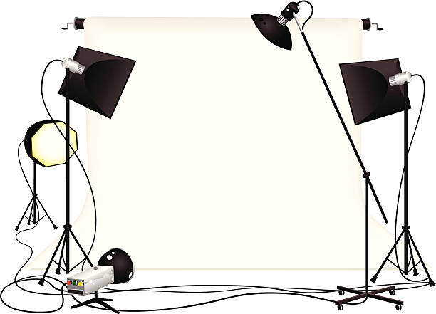 Photography studio and lighting equipment Isolated cartoon style illustration of a typical photography studio set up. Plenty of room in the middle of the illustration for your own objects to photograph! photo studio model stock illustrations