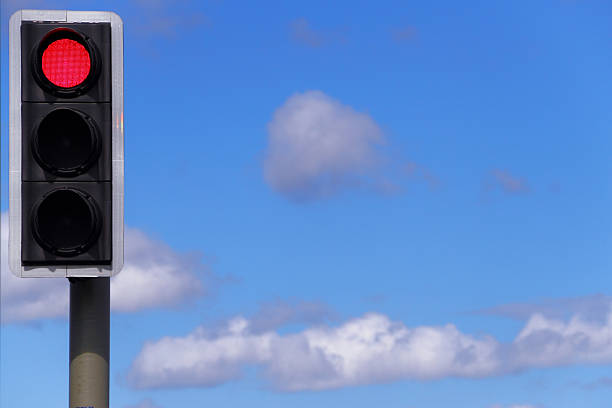 istock Red Traffic Light Against a Blue Cloudy Sky 179193552