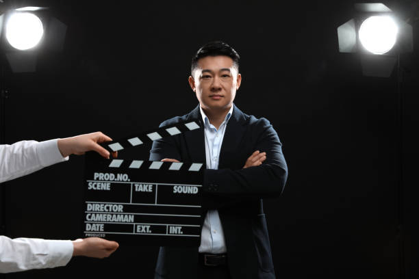 istock Asian actor performing while second assistant camera holding clapperboard on stage. Film industry 1791948254