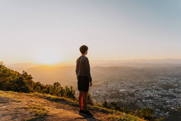 istock Teenage boy looking at sunset view 1791952242