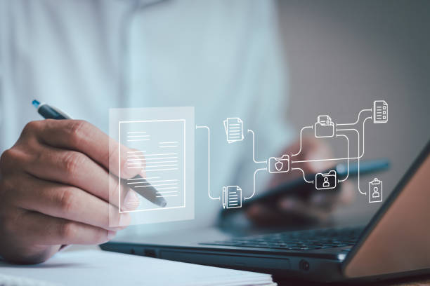 istock Businessman working on a laptop computer with electronic document icons, e-signing, electronic signature, E-document contract management, online documentation database, and paperless office concept. 1791959902