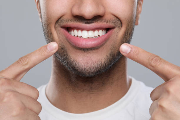 istock Man showing healthy gums on grey background, closeup 1791970089