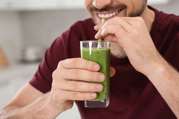 istock Happy man drinking delicious fresh smoothie indoors, closeup 1791970608