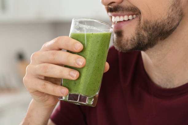 istock Happy man drinking delicious fresh smoothie indoors, closeup 1791970621