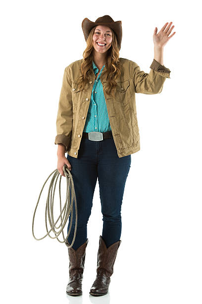 istock Smiling cowgirl standing with waving hands 179197131