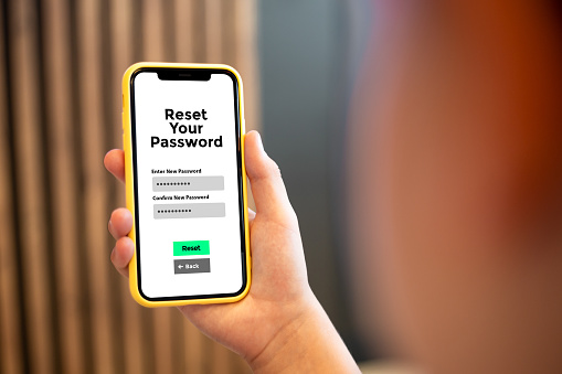 In this compelling image, a young boy holds a mobile phone, engrossed in the innovative concept of a password reset app. The close-up showcases the on-screen action as the child navigates through the user-friendly interface, symbolizing the seamless experience of resetting passwords online. This visually striking composition captures the essence of modern mobile security, emphasizing simplicity and accessibility in the digital age.