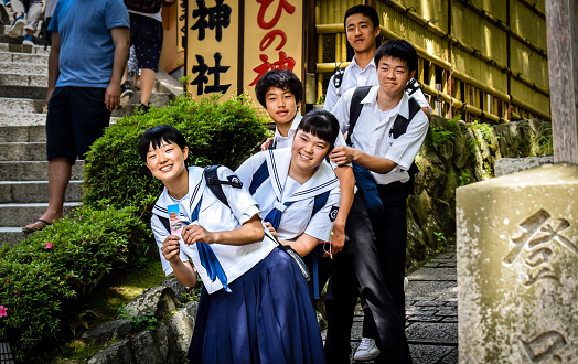 Kyoto, Kyoto prefecture / Japan - 05 12 2018: Japanese schoolchildren in uniform pose for a picture at the shrines at Kiyomizu-dera temple in Kyoto.