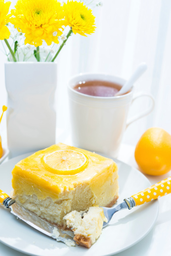 Lemon cheesecake slice with coffee, tea