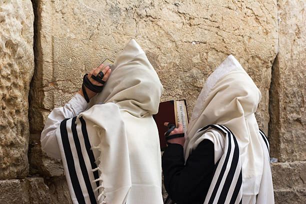 The Western Wall in Jerusalem. Jews pray at the Western Wall in Jerusalem. jewish prayer shawl stock pictures, royalty-free photos & images