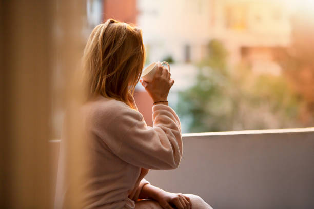 istock Morning Tranquility: Woman Sips Coffee on Balcony, Ready for the Day 1792002993