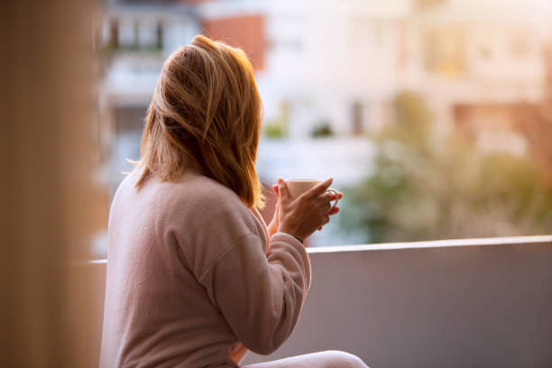 istock Morning Tranquility: Woman Sips Coffee on Balcony, Ready for the Day 1792002994