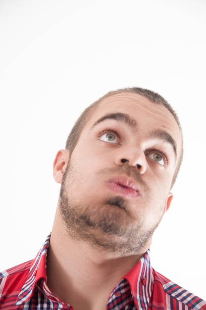 Exasperation clear, upward glance, stubble With a huff of discontent, the man's frustration is as visible as his casual plaid attire rolling eyes irritation displeased facial expression stock pictures, royalty-free photos & images