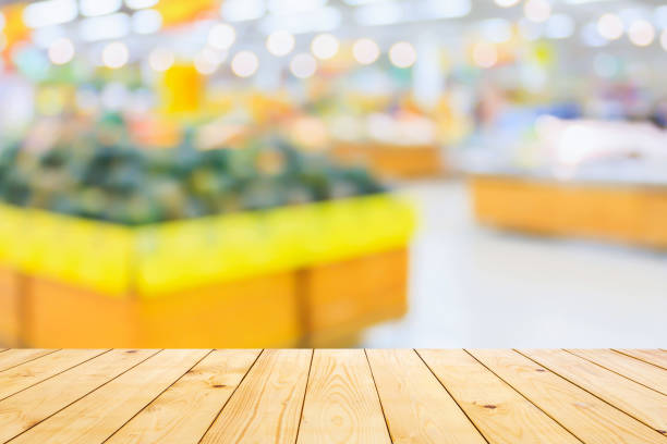 istock Empty wood table top with supermarket blurred background for product display 1792018875