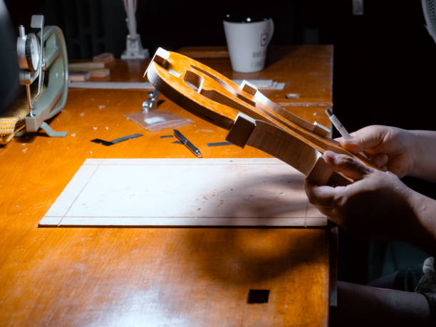 artisan violin maker luthier working with violin mould for center bot, corner blocks , bend ribs for a new classic handmade violin