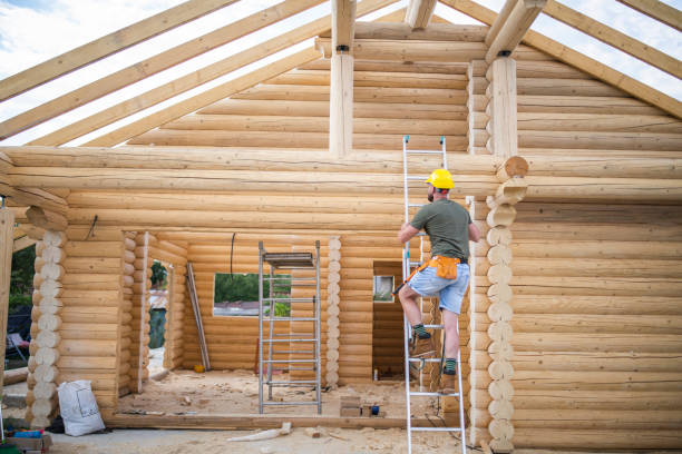 istock Hard working builder on ladder building a log cabin. 1792030300