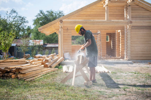 istock Mid adult builder grinding a log for a log cabin house. 1792030303