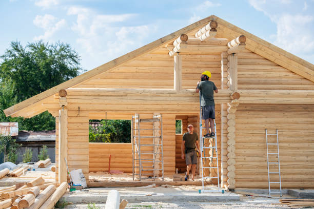 istock Hard working builder on ladder building a log cabin. 1792030823
