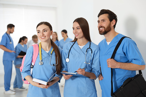 Medical students wearing uniforms in university hallway