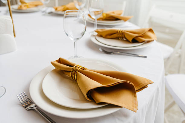 istock Elegance and Simplicity: A White Table Set With Minimalistic White Plates and Shiny Silverware 1792042496