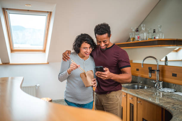 Young couple eating together at home
