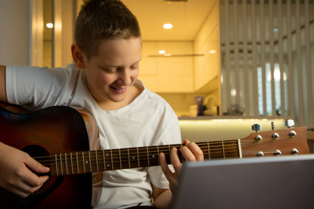 istock Guitar Virtuoso Unleashed: Teen Explores Online Learning in Comfort 1792055463