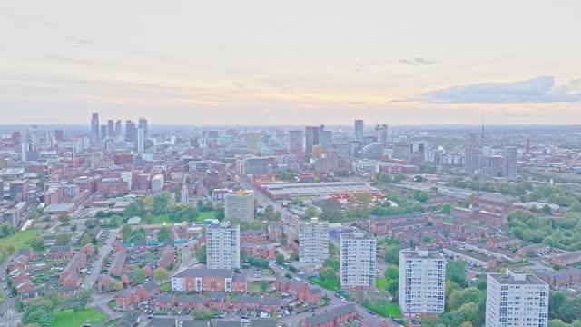 Aerial drone dolley shot of the high rise skyline of Manchester during sunset.
