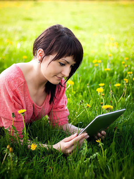 istock woman using tablet outdoor 179208553