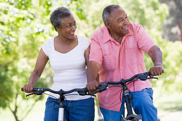 istock Older couple riding bikes in park 179208763