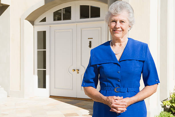 istock Retired woman standing outside house 179208886