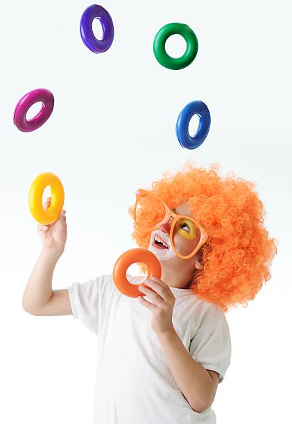 Cute funny clown child on white background stock photo