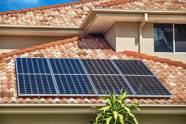 Solar panels on home Solar panels on suburban Australian home house residential structure roof rooftiles stock pictures, royalty-free photos & images