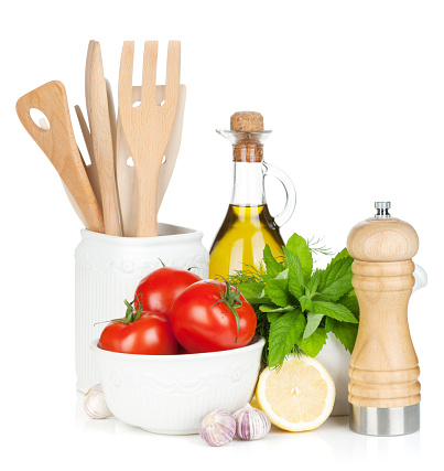 Fresh ripe vegetables, condiments and kitchen utensils. Isolated on white background