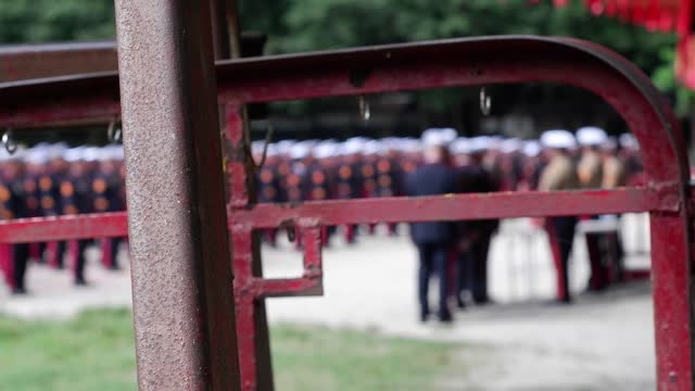 Marine soldiers aspired to upgrade promotion on standing formation to receive a graduation certificate diploma. Junk metal obscure view. Creative unreleased (editorial use only). blurs