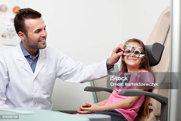 Optometrist Examines The Sight Of Young Girl Stock Photo - Download Image Now - Adult, Beautiful People, Care